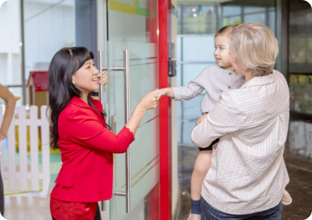 image of two adult people with a one toddler