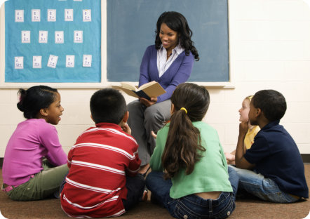 five kids listening to an adult talking