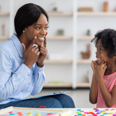 woman and little girl smiling