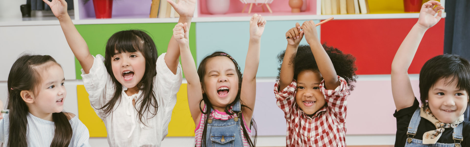 children raising their hands