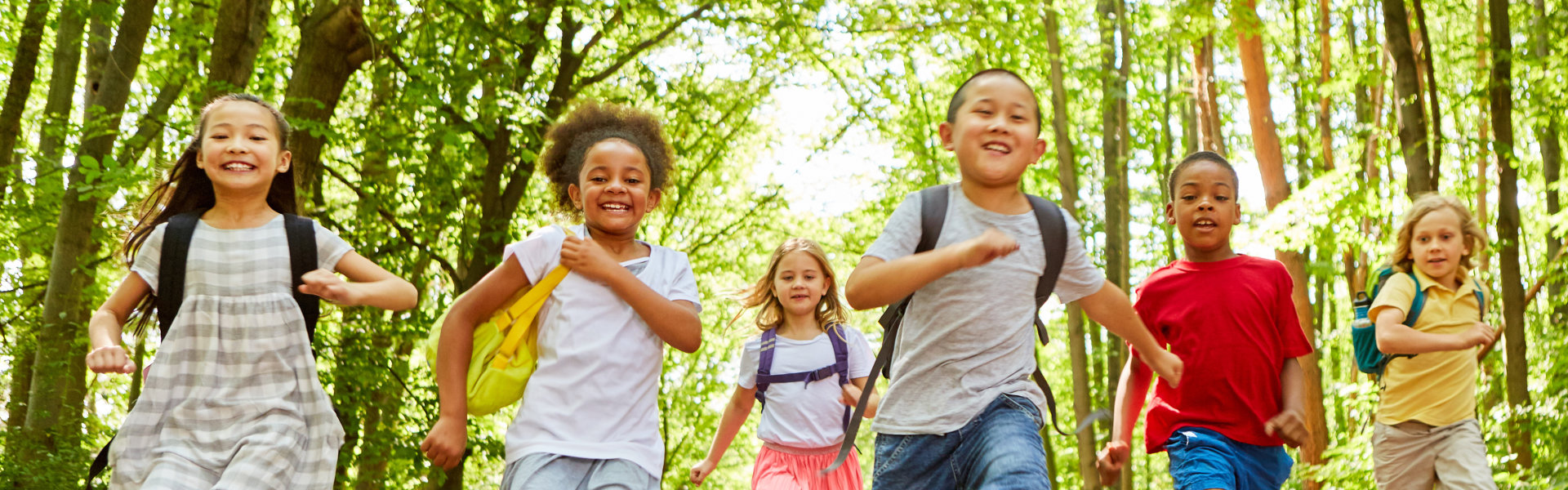 children running in a forest