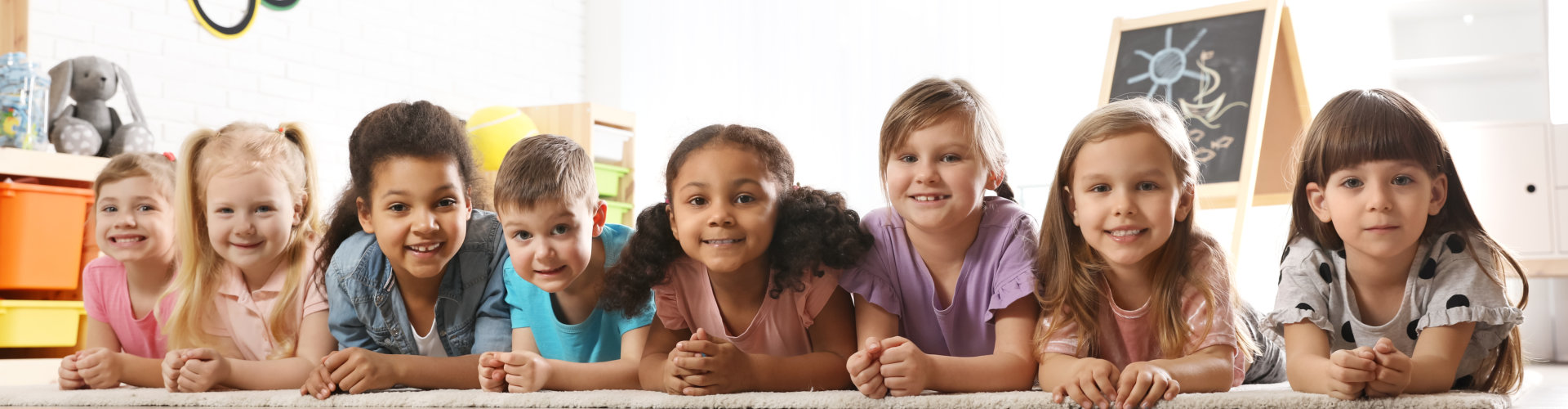 Group of cute little children lying on floor