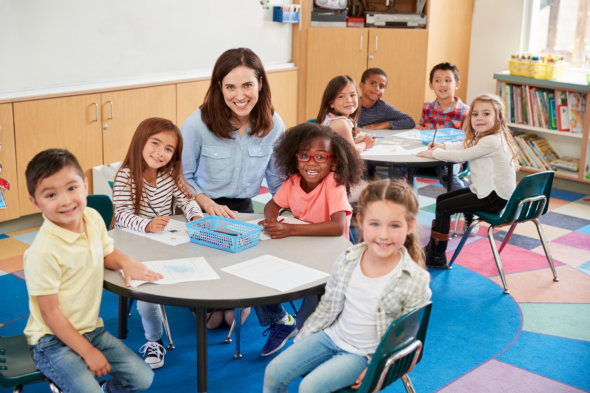 image of the students and the teacher smiling